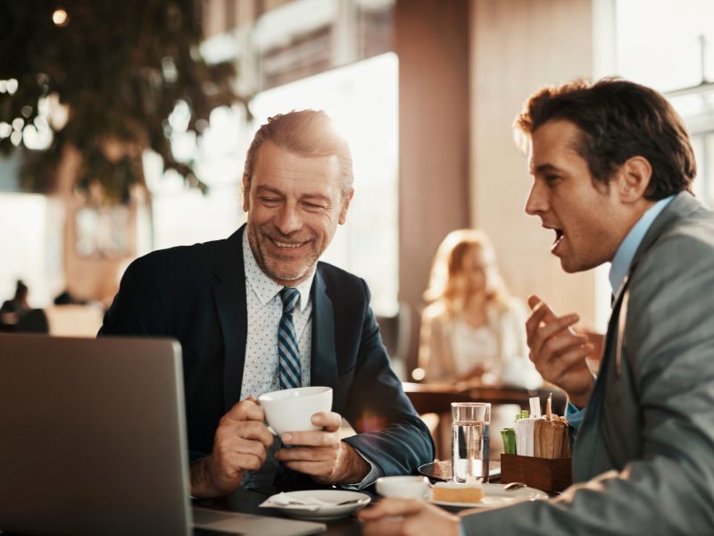 Business owner meeting with broker discussing optimal timing for business sale