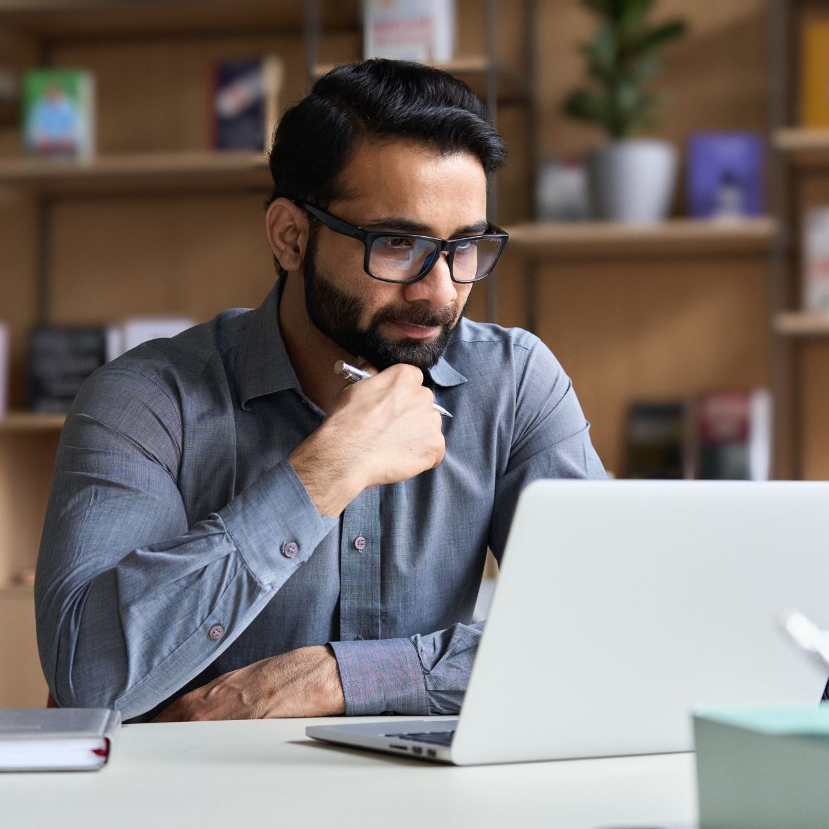 Professional at desk computer, thinking